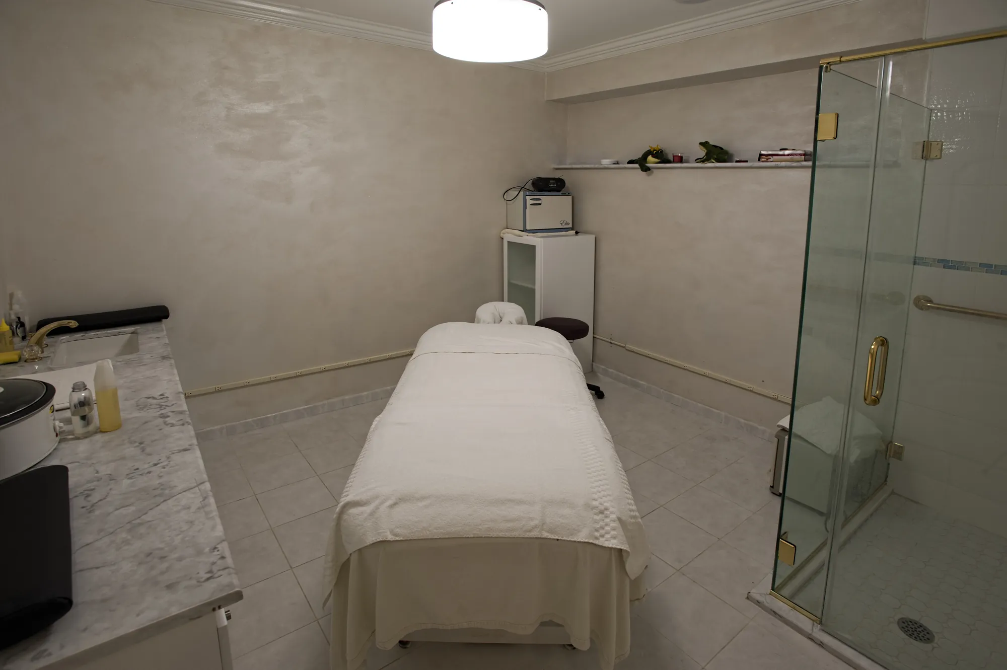 A treatment room with a glass shower.